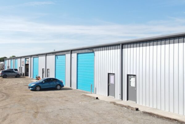 Aerial view of a single-story flex space building with large windows, landscaping, and accessible parking spaces.