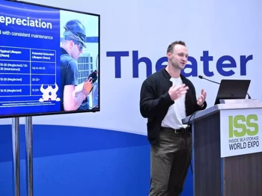 Male presenter talks at a lectern on a conference stage, a large slide about depreciation displayed beside him. The ISS World Expo branding is visible on the podium.